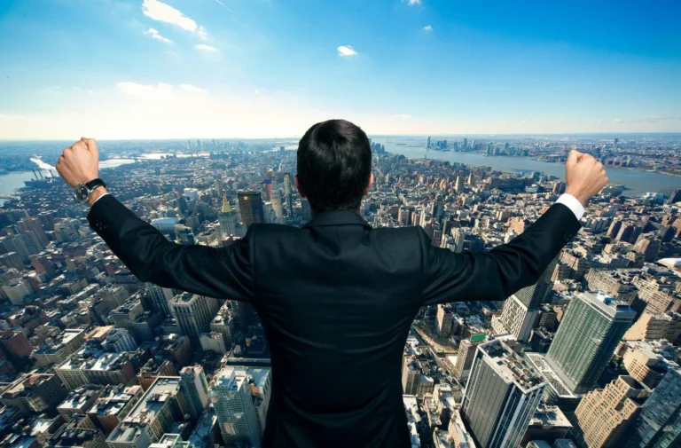 businessman-raising-his-arms-in-front-of-a-big-city